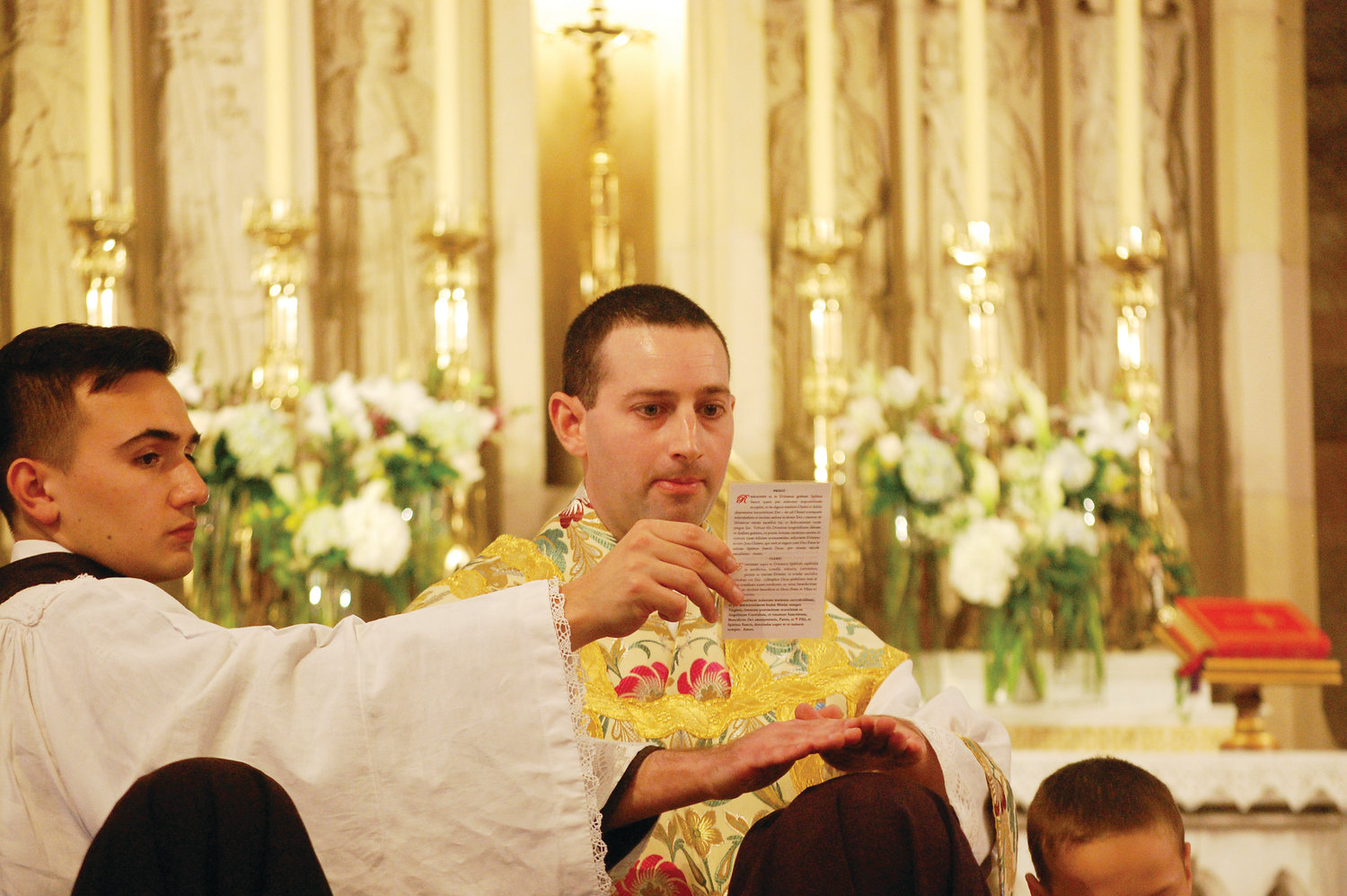 Father Rock confers a priestly blessing after his ordination.